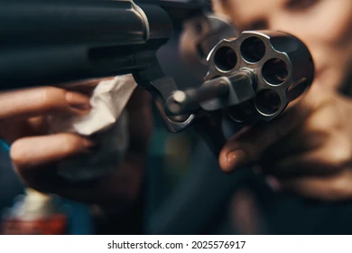 female-sniper-wiping-her-revolver-260nw-2025576917